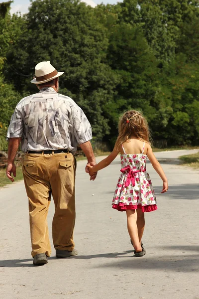 Grandfather with the grandson go on road — Stock Photo, Image