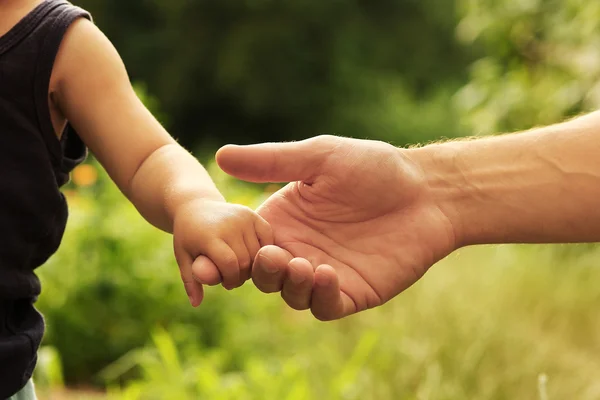 Bovenliggende houdt de hand van kind — Stockfoto