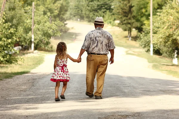 Grandfather with granddaughter  on road — Stock Fotó