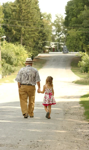 Grandfather with the granddaughter   on road — Stock Photo, Image