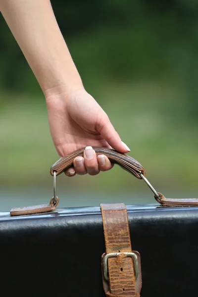 Female hand with suitcase — Stock Photo, Image