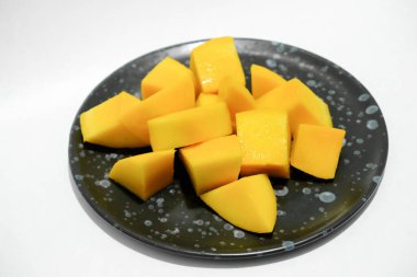 Siyah seramik tabakta olgun mangolar..