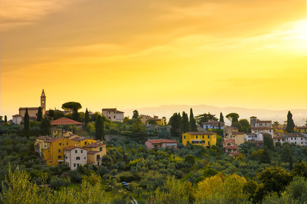 Town in the hills at sunset, Tuscany, Italy