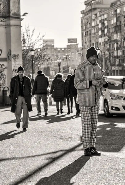 Homeless man holding a kangaroo toy in his hands and begging — Stock Photo, Image