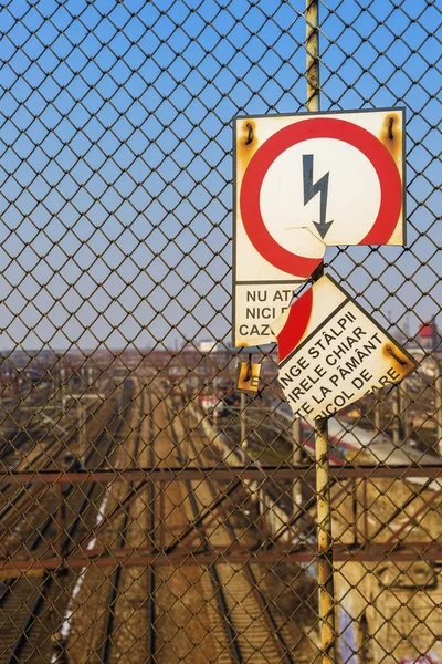 Broken sign showing risk of electric shock — Stock Photo, Image