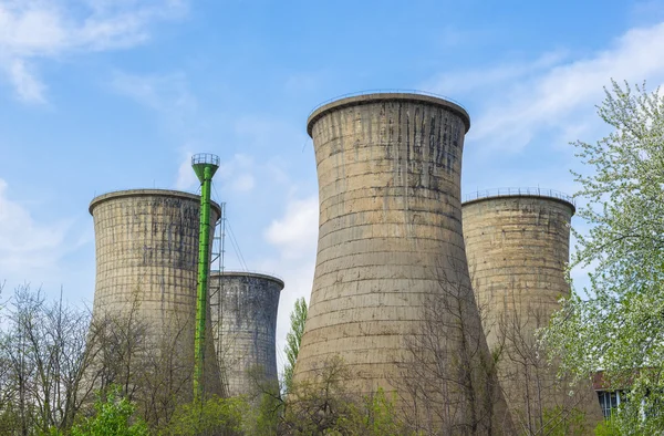 Power plant towers in spring green landscape and blue sky — Stock Photo, Image