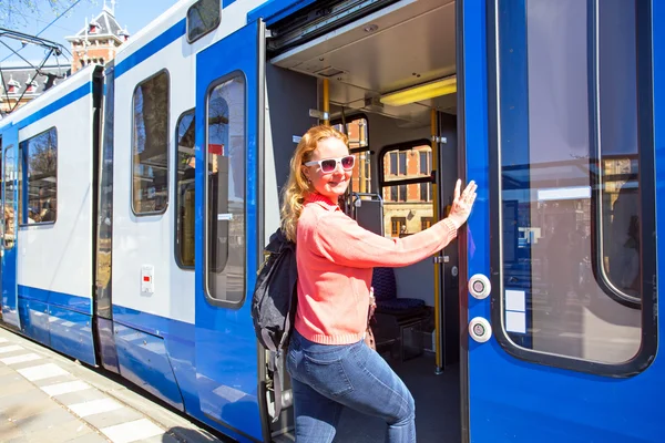 Young native dutch woman getting on the tram at the station in A — Stock Photo, Image