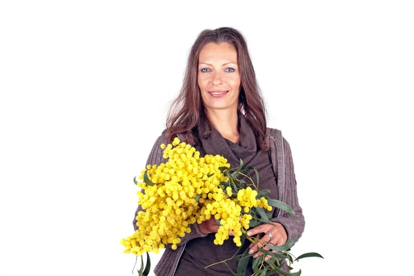 Beautiful woman with blossoming mimosa — Stock Photo, Image