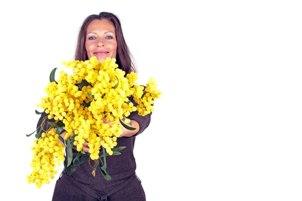 Beautiful woman with blossoming mimosa — Stock Photo, Image