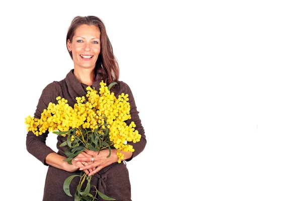 Beautiful woman with blossoming mimosa — Stock Photo, Image