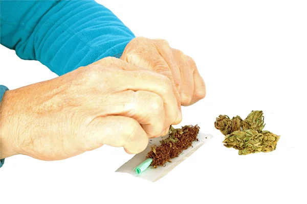 Man making a joint from marijuana — Stock Photo, Image