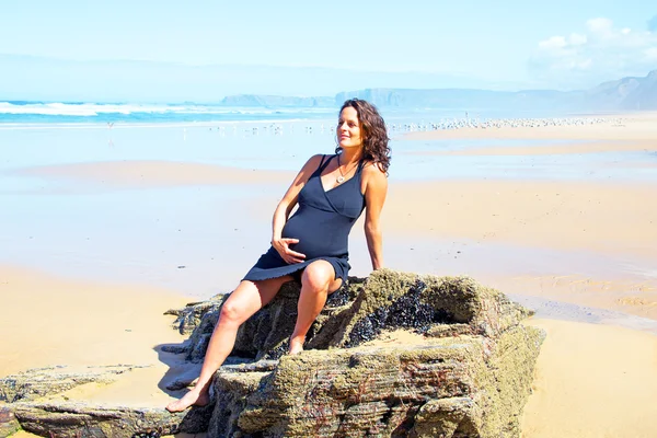 Mulher grávida na praia no oceano atlântico — Fotografia de Stock