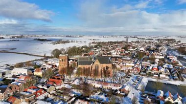 Geleneksel binaların soğuk koşullarda sergilendiği karlı, tarihi bir Avrupa şehrini gösteren kış sahnesi