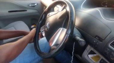 NAIROBI, KENYA - 11 Mart 2021: Nissan aracı sürüyorum. Araba kullanan Afrikalı bir adam. Nairobi, Kenya. Sürücü kavramı.