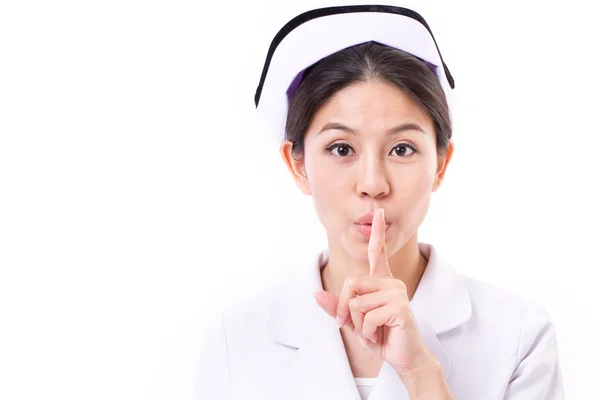 Zdravotní sestra žádá o mlčení gestem ruky — Stock fotografie