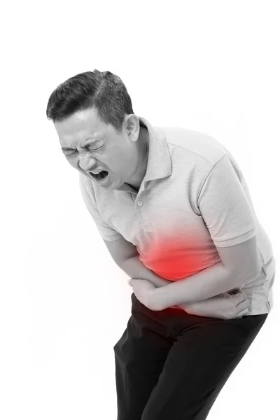 Азиатский мужчина страдает от боли в животе, запоров, несварения желудка — стоковое фото