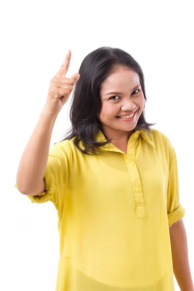 Жінка середнього віку, що вказує на 1 палець — стокове фото