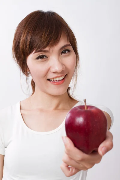 Gezonde Aziatische vrouw geven rode appel — Stockfoto