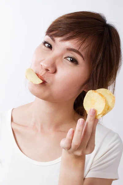 Woman eating fried potato chip — Stock Photo, Image