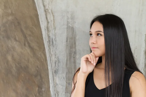 Woman thinking gesture with hand on her chin — Stock Photo, Image