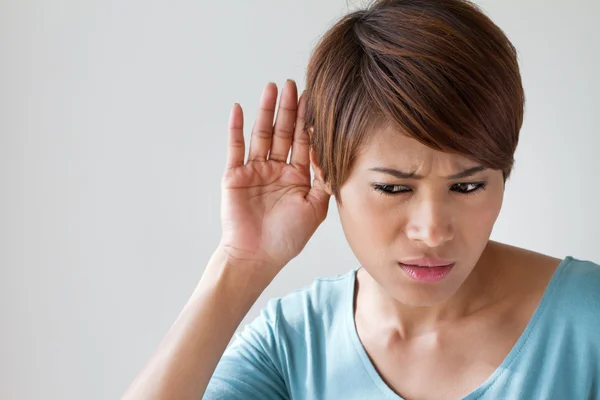 Woman suffers from hearing impairment, hard of hearing, hearing impair — Stockfoto