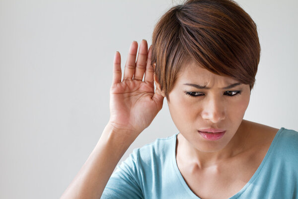 woman suffers from hearing impairment, hard of hearing, hearing impair