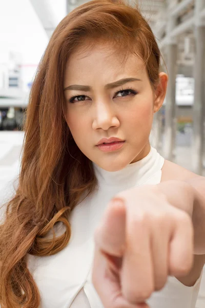 Serious woman pointing finger at you — Stock Photo, Image