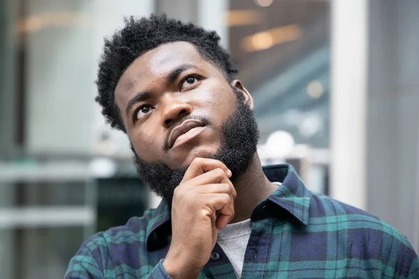 Serious African black man thinking, planning finding good idea