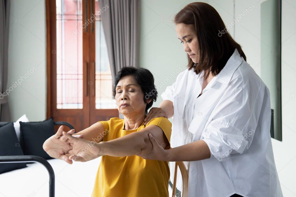 Asian caregiver taking care of retired senior woman, concept of retirement, old age home, senior home, pensioner service, caretaker business