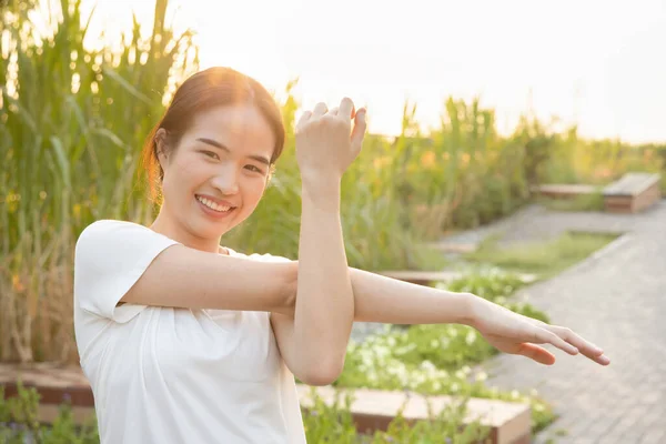 healthy happy active woman working out in urban park, prayer hands, concept of asian woman with green nature, healthy lifestyle, people in nature, fresh air, no pollution, healthy people