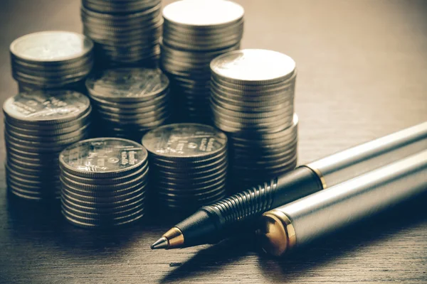 Money concept coins and pen with filter effect retro vintage sty — Stock Photo, Image