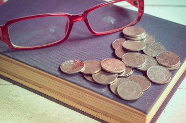 Eski kitaplar ve filtre etkisi retro vintage tarzı ile ahşap bir masa üzerinde gözlük