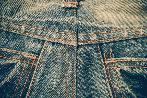 Tekstura tło niebieskie jeansy z filtr efektu retro ubierania — Zdjęcie stockowe