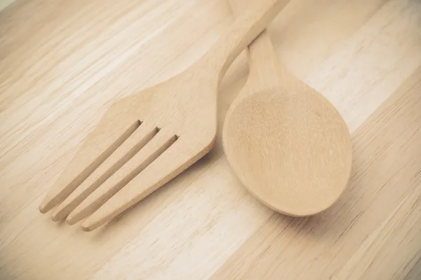 Wooden spoon on wood table with filter effect retro vintage styl