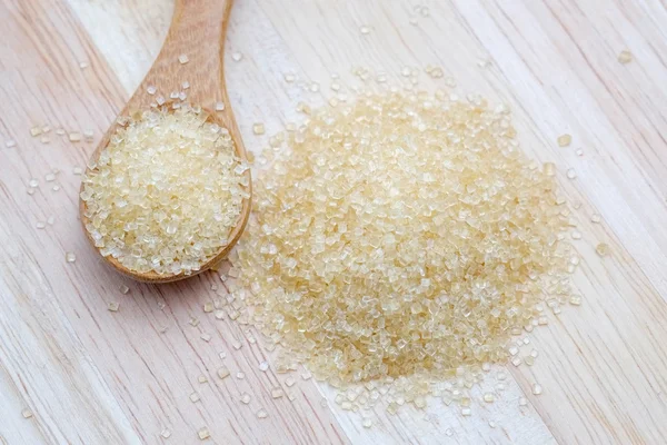 Brown sugar heap on wooden table — Stock Photo, Image