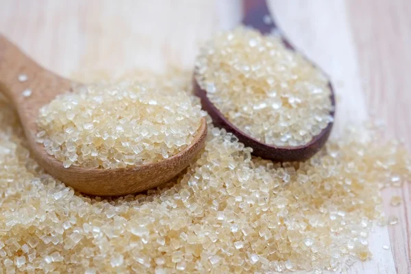 Brown sugar heap on wooden table — Stock Photo, Image