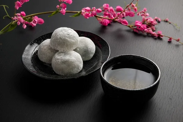 Japonés dulce negro sésamo daifuku sobre fondo de madera negro — Foto de Stock