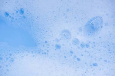 Soyut arka plan beyaz sabunlu köpük dokusu. Köpüklü şampuan köpüğü.