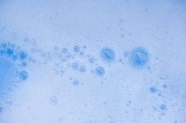 Soyut arka plan beyaz sabunlu köpük dokusu. Köpüklü şampuan köpüğü.