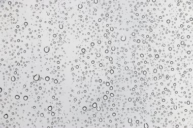 Pencere cam dokusu üzerine yağmur damlaları