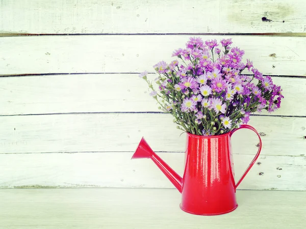 Flowers and watering can old retro vintage style — Stock Photo, Image