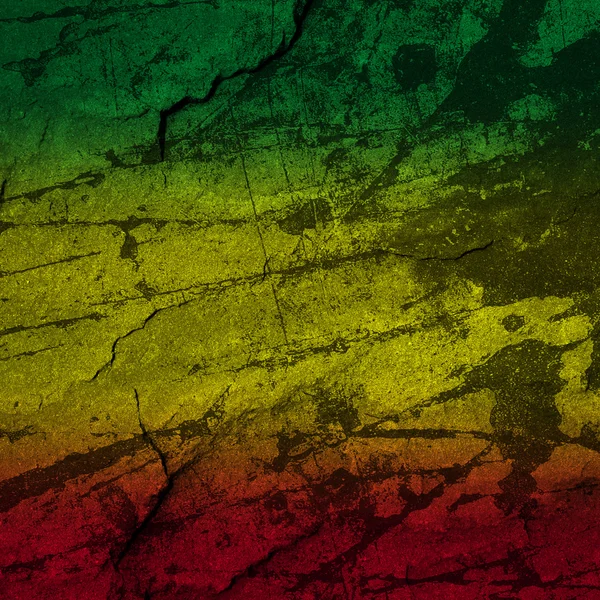 Kırmızı, sarı, yeşil rasta bayrak taş duvar — Stok fotoğraf