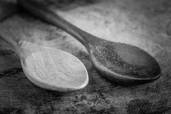Black and white Spoon on a wood table — Stock Photo, Image