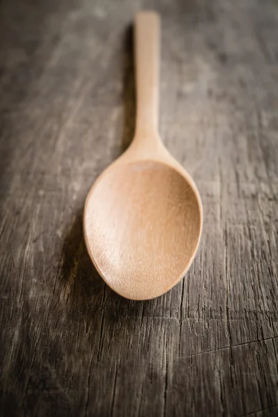 Wooden spoon  on wood table with filter effect retro vintage style — Stock Photo, Image