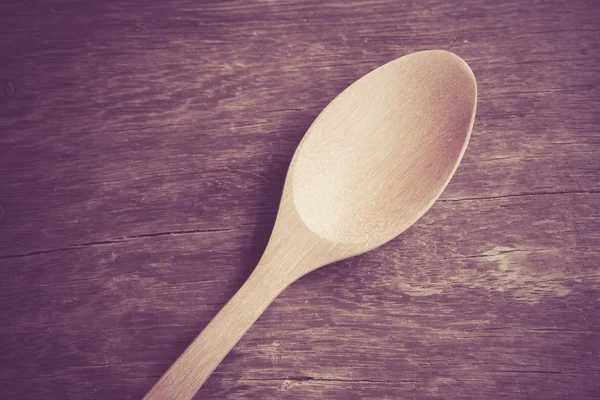 Wooden spoon  on wood table with filter effect retro vintage style — Stock Photo, Image