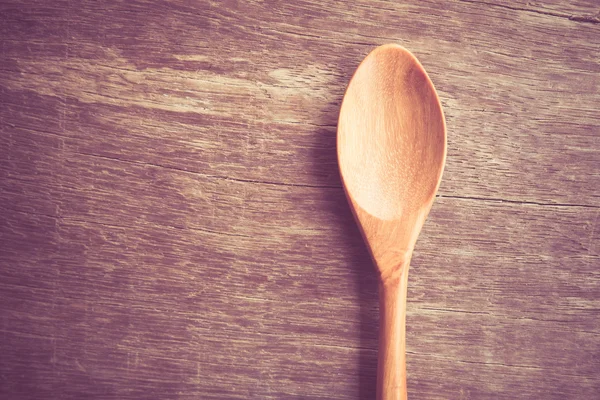 Wooden spoon  on wood table with filter effect retro vintage style — Stock Photo, Image