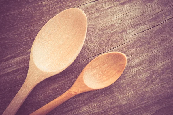 Wooden spoon  on wood table with filter effect retro vintage style — Stock Photo, Image