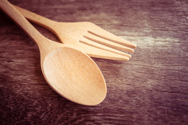 Wooden spoon  on wood table with filter effect retro vintage style