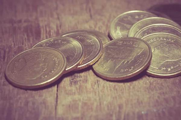 Monedas en madera con efecto de filtro estilo retro vintage — Foto de Stock