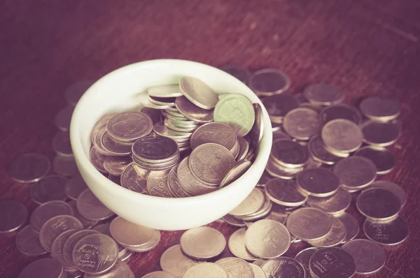 Coin in the cup with filter effect retro vintage style — Stock Photo, Image